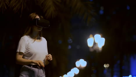 Junges-Mädchen-Simulierte-Virtual-Reality-Arbeit-In-Einer-Brille-In-Einer-Modernen-Großstadt-Bei-Nacht-Auf-Meinen-Laternen-Und-Einem-Wunderschönen-Bokeh-Von-Vorbeifahrenden-Autos-Und-Gebäuden